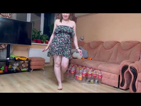 Sorting, recycling and crushing 22 plastic bottles of Coca Cola in Mini dress