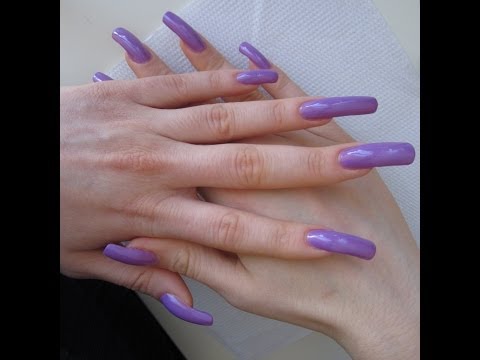 Applying lilac nail polish