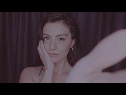 ASMR soft whispering, hand movements, mouth and tapping sounds, and gentle music